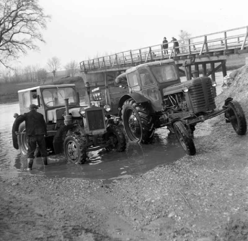 Men wash their tractors in the Elbe near Magdeburg in Saxony - Anhalt