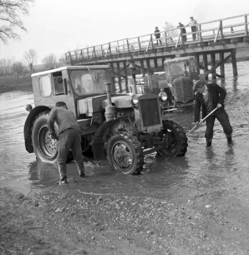 Men wash their tractors in the Elbe near Magdeburg in Saxony - Anhalt