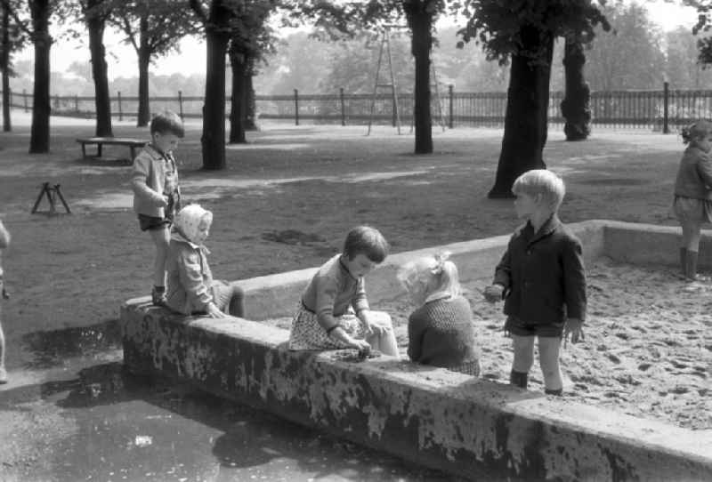 Children playing in the sandbox on a playground in Magdeburg