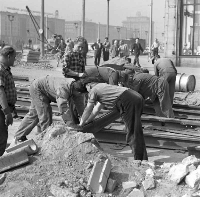 Track workers in the laying of rails on the street Breiter Weg in Magdeburg