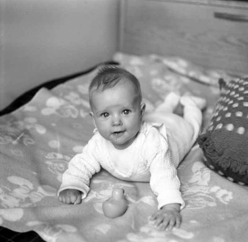 A baby lies on a playmat in Magdeburg