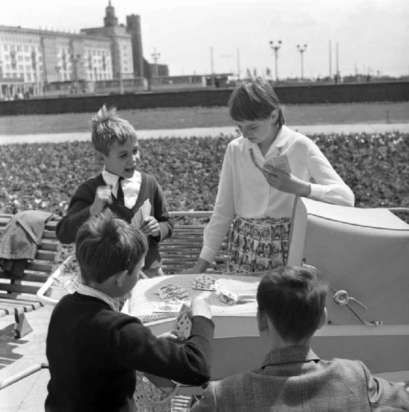 Children playing cards outdoors in Magdeburg