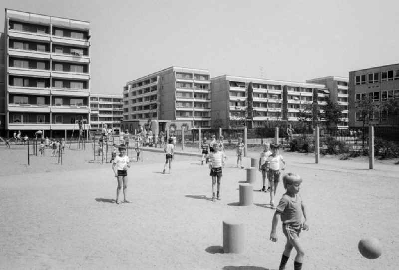 Children play on the playground in a residential area settlement in the part of town of Olvenstedt in Magdeburg in the federal state Saxony-Anhalt in the area of the former GDR, German democratic republic