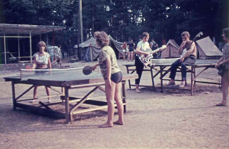 Summer camp operation with pupils and teenagers on table tennis tables on street Fuerstenberger Strasse in Menz, Brandenburg on the territory of the former GDR, German Democratic Republic