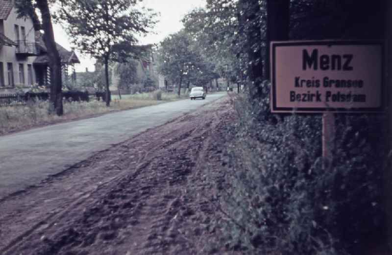 Town entrance sign placed on the side of the road on street Fuerstenberger Strasse in Menz, Brandenburg on the territory of the former GDR, German Democratic Republic