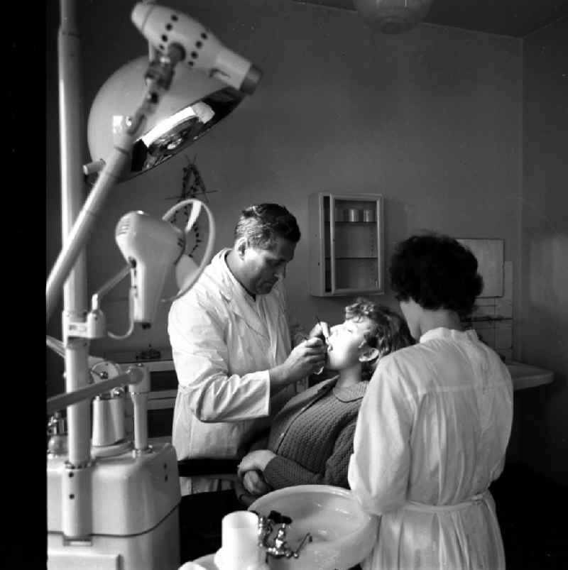 Dentist working on the patient for dental care in a practice in Mestlin in the state Mecklenburg-Western Pomerania on the territory of the former GDR, German Democratic Republic