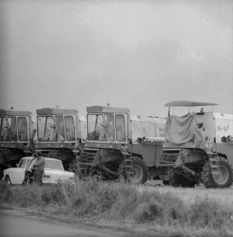 Combine harvesters arm for the journey in the south districts of the republic to the harvest of grain in Michendorf in the federal state Brandenburg in the area of the former GDR, German democratic republic