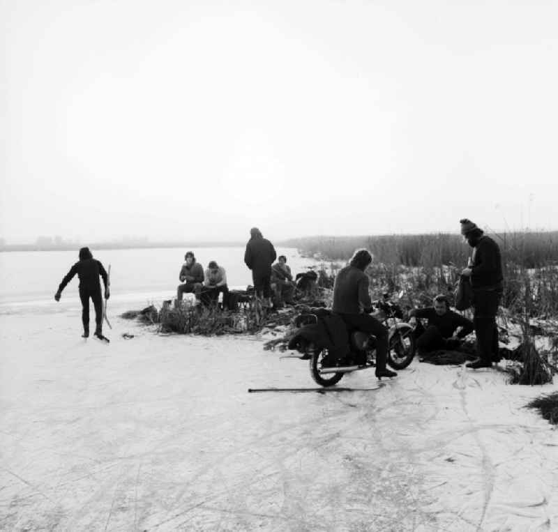 Teens meet on a frozen lake for ice hockey in Mittenwalde in Brandenburg on the territory of the former GDR, German Democratic Republic