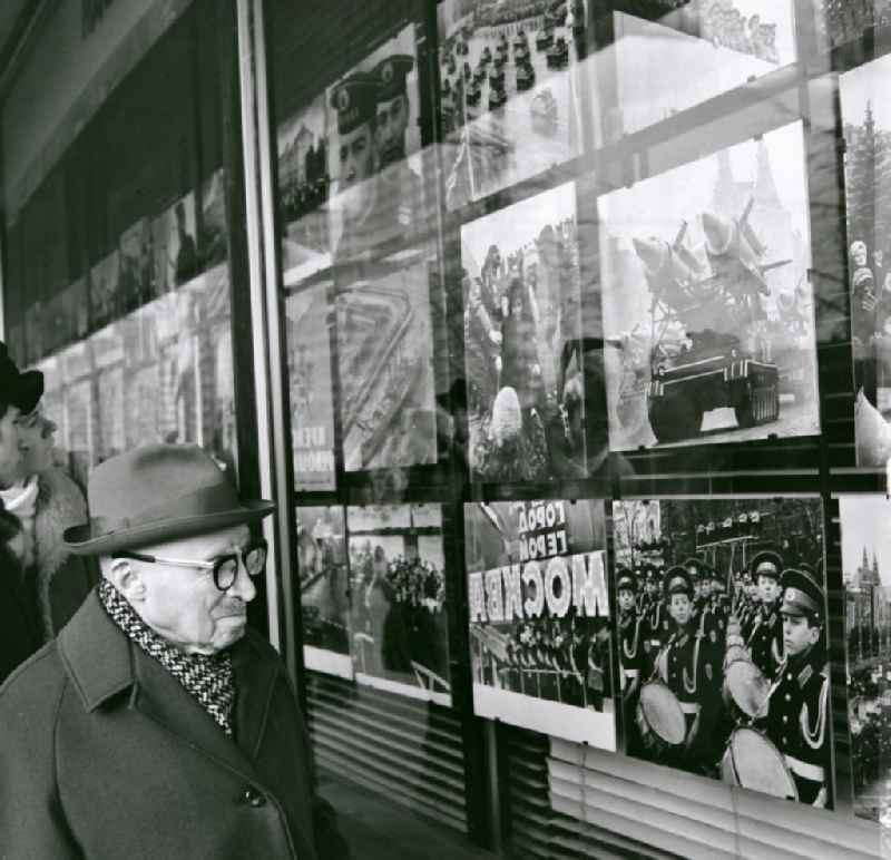 A man looks at a photo exhibition in a shop window in Moscow in Russia
