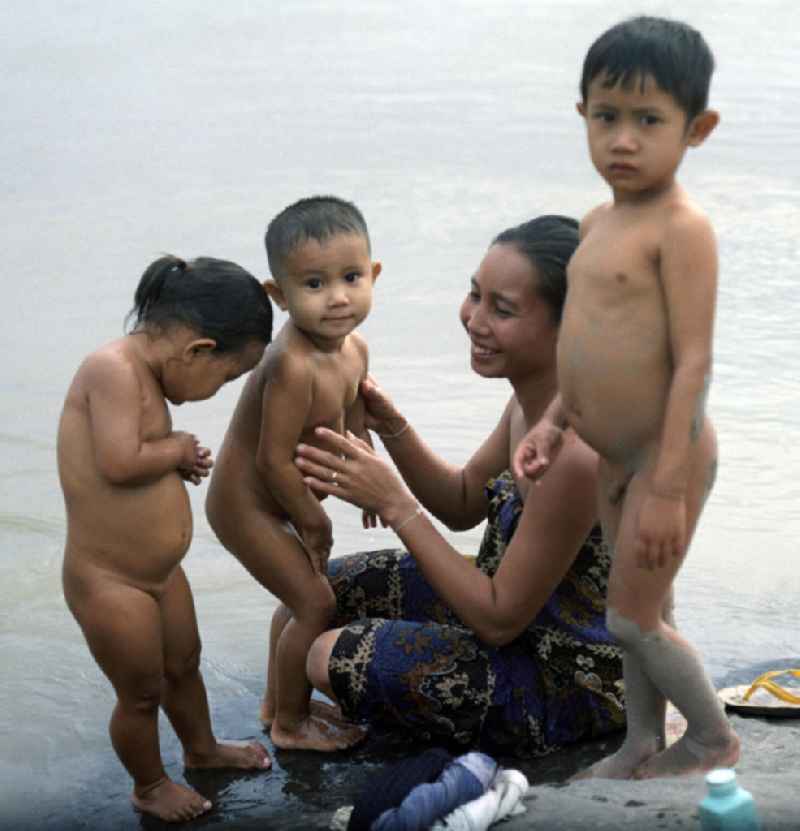 Frauen baden und waschen ihre Kinder im Fluß Mekong in der Demokratischen Volksrepublik Laos.