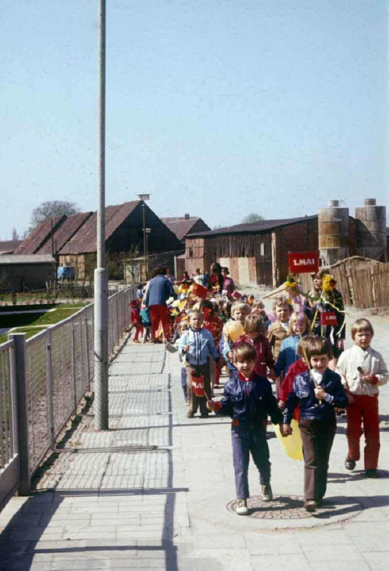 A nursery school group, with balloons and flags, on the way to May 1 demonstration in Neustrelitz in Mecklenburg-Vorpommern in the territory of the former GDR, German Democratic Republic