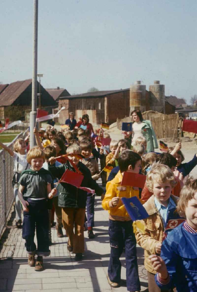 A nursery school group, with balloons and flags, on the way to May 1 demonstration in Neustrelitz in Mecklenburg-Vorpommern in the territory of the former GDR, German Democratic Republic