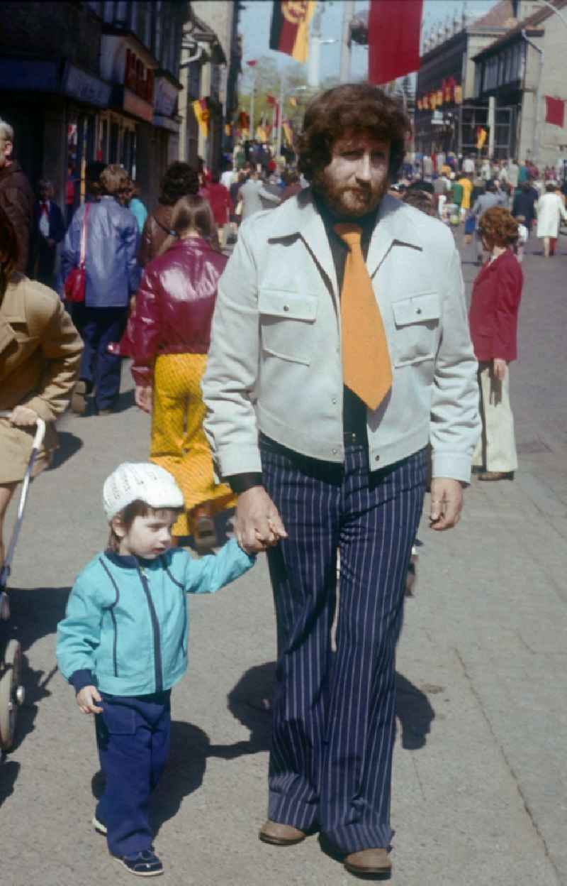A father with child at the 1st of May demonstration in Neustrelitz in Mecklenburg-Vorpommern in the territory of the former GDR, German Democratic Republic