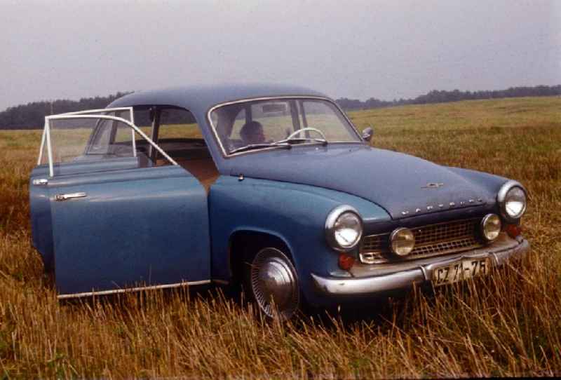 A child sitting in the driver's seat in a Wartburg 311 on a field in Neustrelitz in the state of Mecklenburg-Western Pomerania in the territory of the former GDR, German Democratic Republic