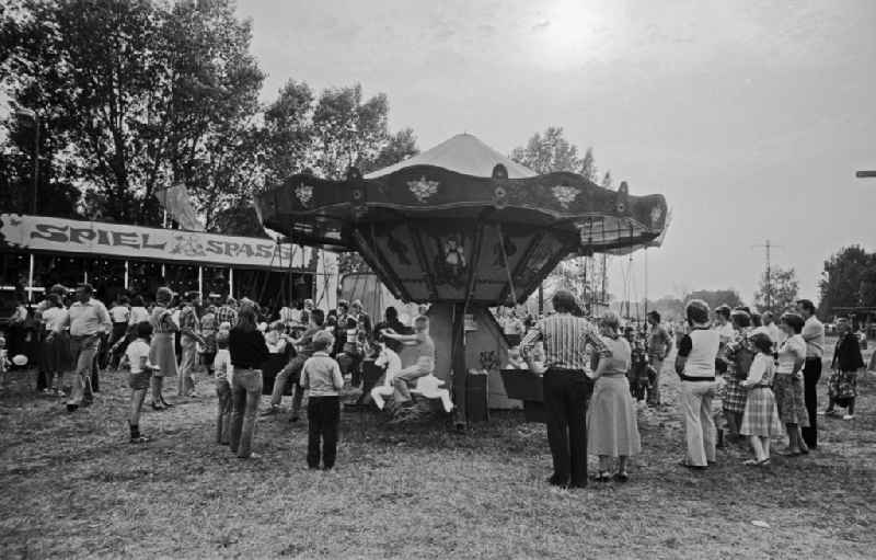 Residents and guests as participants in the events on the occasion of a village festival with fairground rides in Paaren, Brandenburg on the territory of the former GDR, German Democratic Republic