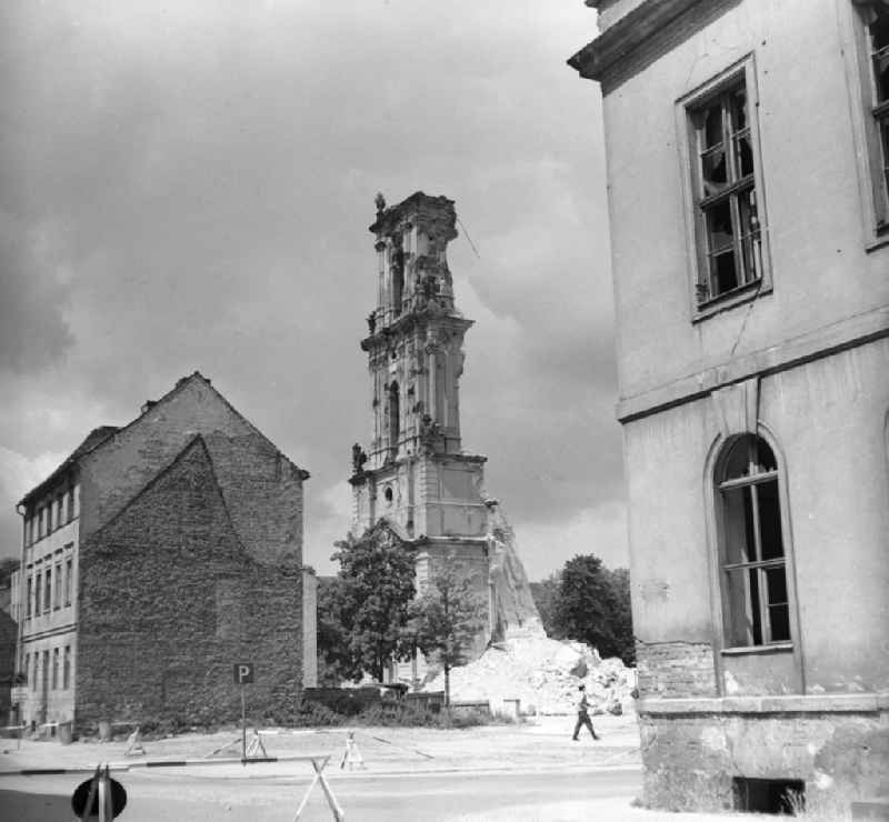 Abriss der Garnisonkirche. Reste des Glockenturms gesehen aus der Potsdam 23.07.1968 Abriss der Garnisonkirche. Blick von der Bauhofstraße auf die Reste vom Glockenturm. Rechts im Vordergrund eines der beiden Knobbelsdorfhäuser. Die Garnisonkirche Potsdam wurde von Philipp Gerlach zwischen 1730 und 1735 auf Befehl Friedrich Wilhelm I. errichtet. Sie galt als ein Hauptwerk des preußischen Barock. Mit einem 88,40 Meter hohen Glockenturm überragte sie die anderen Bauten der Stadt. In der offenen Turmlaterne befand sich ein holländisches Glockenspiel mit 4
