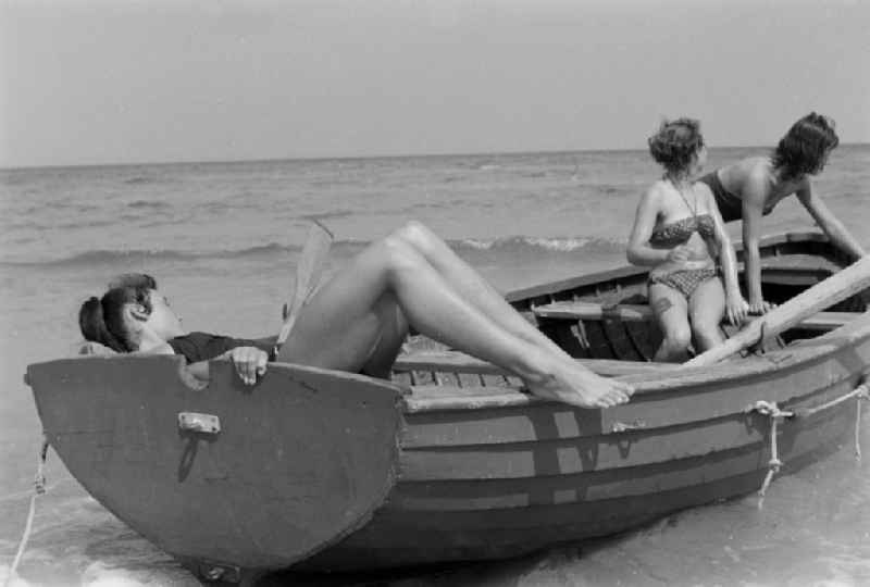 Rowboat in motion with young girls on the Baltic Sea in Prerow in the state Mecklenburg-Western Pomerania on the territory of the former GDR, German Democratic Republic