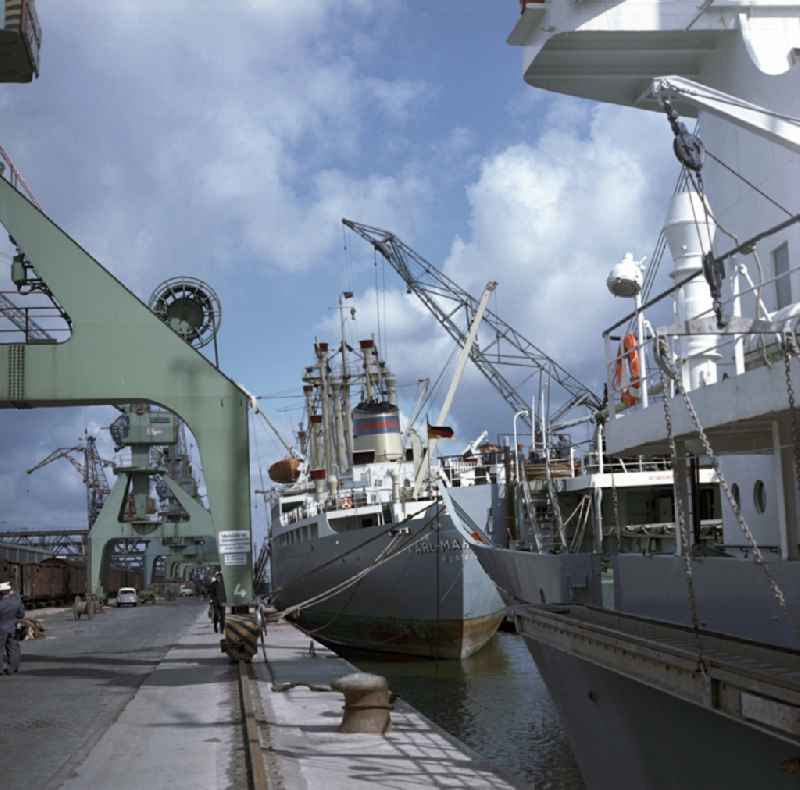 Merchant ships in the seaport of Rostock in Mecklenburg - Western Pomerania. Here during loading at the port. By the division of Germany resulted in the need to build on the Baltic coast of East Germany a seaport