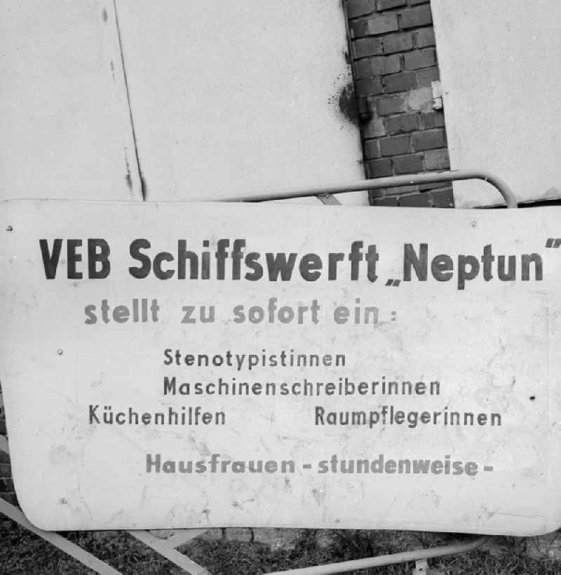 Sign of the dockyard VEB Neptune about open jobs in Rostock in the federal state Mecklenburg-West Pomerania in the area of the former GDR, German democratic republic. Shorthand typists, Machines writers, culinary facilities, cleaners and housewives are searched (by the hour)