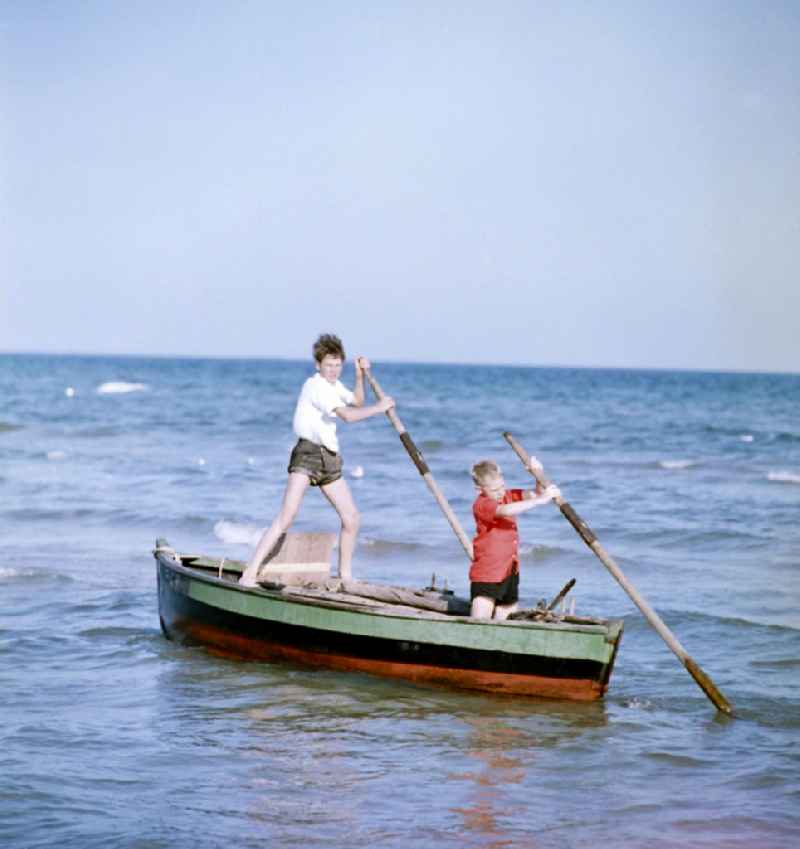 Two children on a boat at the Baltic Sea in Rostock in the state Mecklenburg-Western Pomerania on the territory of the former GDR, German Democratic Republic