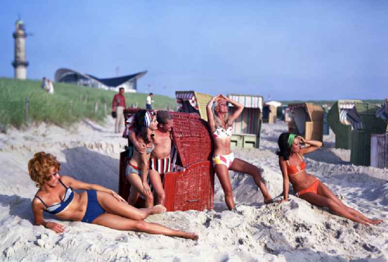 Young people present the latest summer swimwear on the Baltic Sea beach in the district Warnemuende in Rostock in the state Mecklenburg-Western Pomerania on the territory of the former GDR, German Democratic Republic