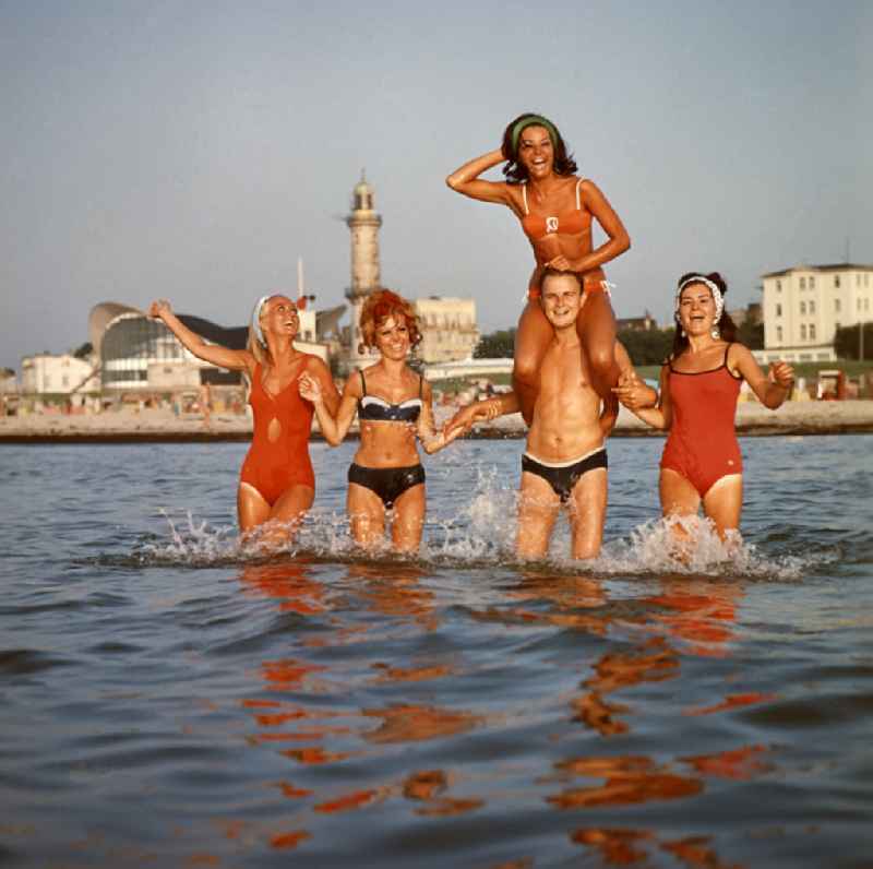 Young people present the latest summer swimwear on the Baltic Sea beach in the district Warnemuende in Rostock in the state Mecklenburg-Western Pomerania on the territory of the former GDR, German Democratic Republic