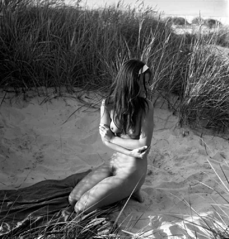 Nude photo of a young woman on the nudist beach on the Baltic Sea in the former capital of the GDR, German Democratic Republic