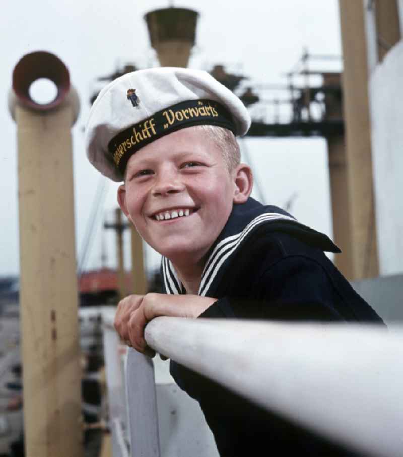 A boy in sailor's uniform pose on the pioneer ship 'Vorwaerts' in Rostock, Mecklenburg-Vorpommern in the territory of the former GDR, German Democratic Republic