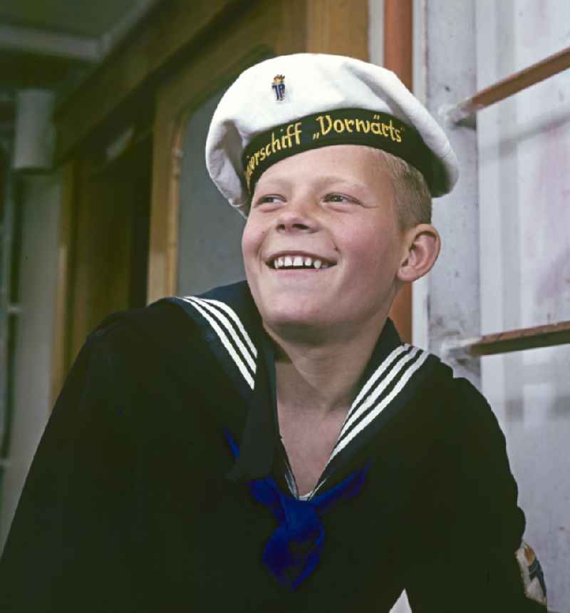 A boy in sailor's uniform pose on the pioneer ship 'Vorwaerts' in Rostock, Mecklenburg-Vorpommern in the territory of the former GDR, German Democratic Republic