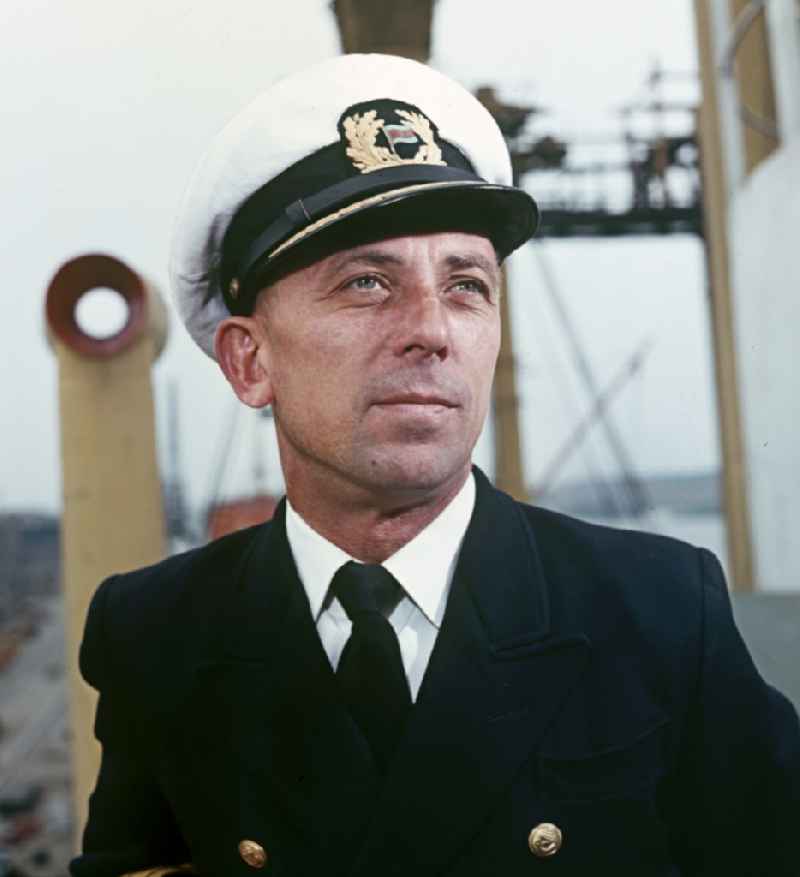 A man in captain's uniform pose on the pioneer ship 'Vorwaerts' in Rostock, Mecklenburg-Vorpommern in the territory of the former GDR, German Democratic Republic