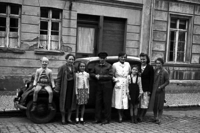 Family admission before an Opel P4 convertible saloon in outwash plain village-Brehna in the federal state Saxony-Anhalt in Germany