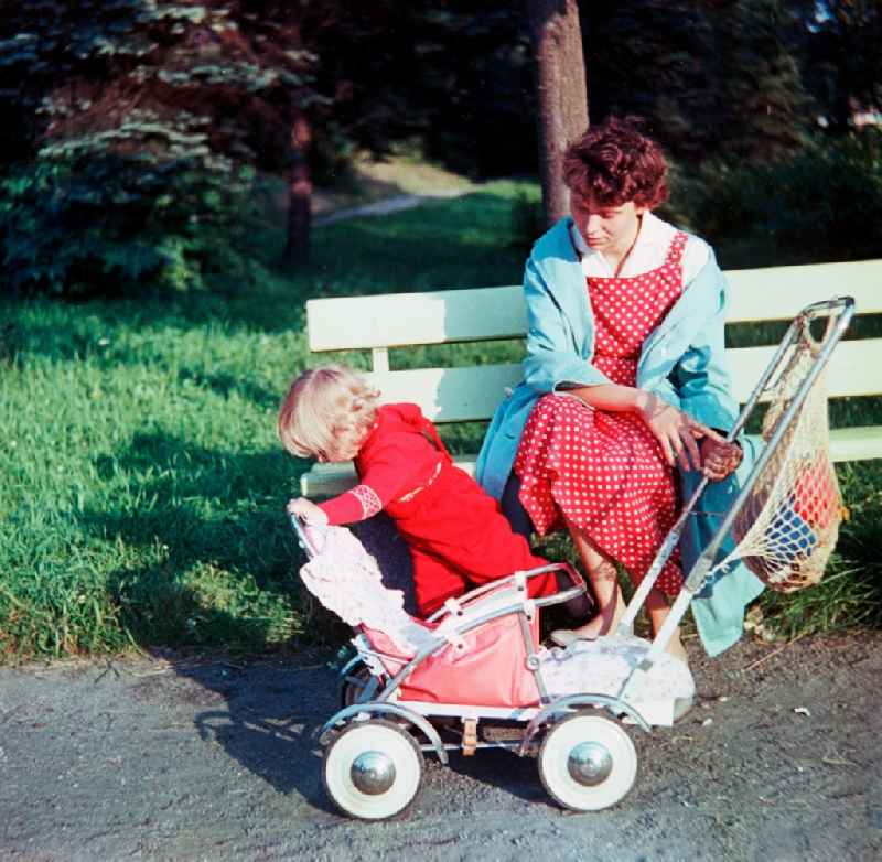 A mother with child with the walk in a park in Schlettau in the federal state Saxony in the area of the former GDR, German democratic republic