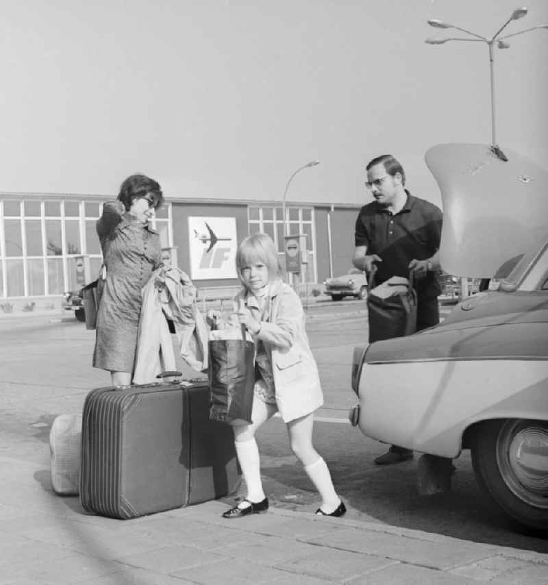 Family with luggage at Berlin airport - Schoenefeld in Schoenefeld in today's federal state of Brandenburg