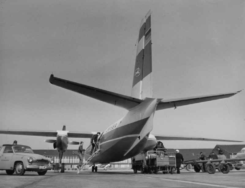 An aircraft of type AN-24 INTERFLUG is loaded with luggage and refueled in Schoenefeld in today's Brandenburg. The Antonov An-24 is a short-haul passenger and cargo aircraft of Soviet origin