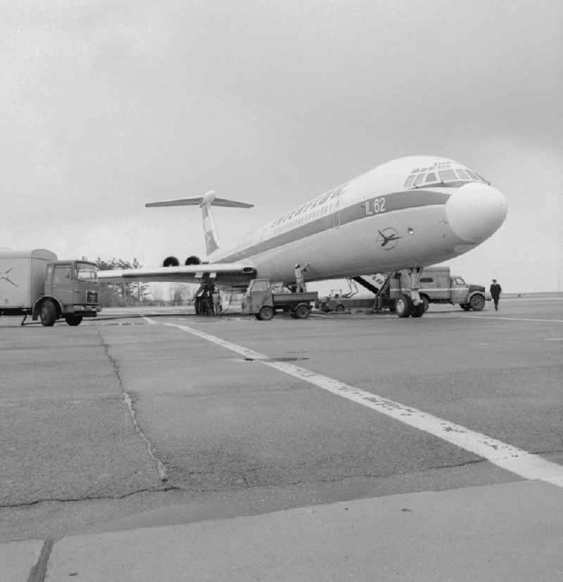 An aircraft of type IL-62 with the identifier of INTERFLUG DM-SEH at the airport Berlin-Schoenefeld in Schoenefeld in Brandenburg today. Here at the refueling and maintenance