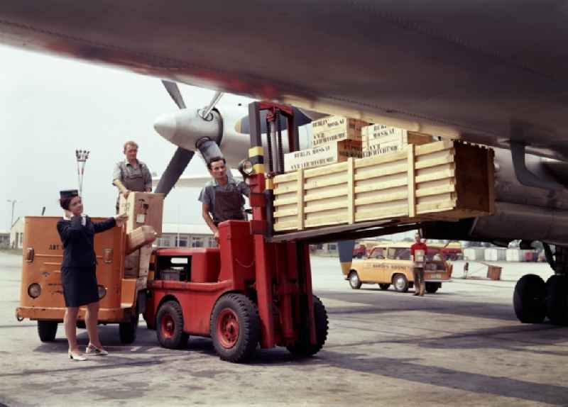 Ground staff loading an Interflug aircraft at the airport in Schoenefeld in the state Brandenburg on the territory of the former GDR, German Democratic Republic
