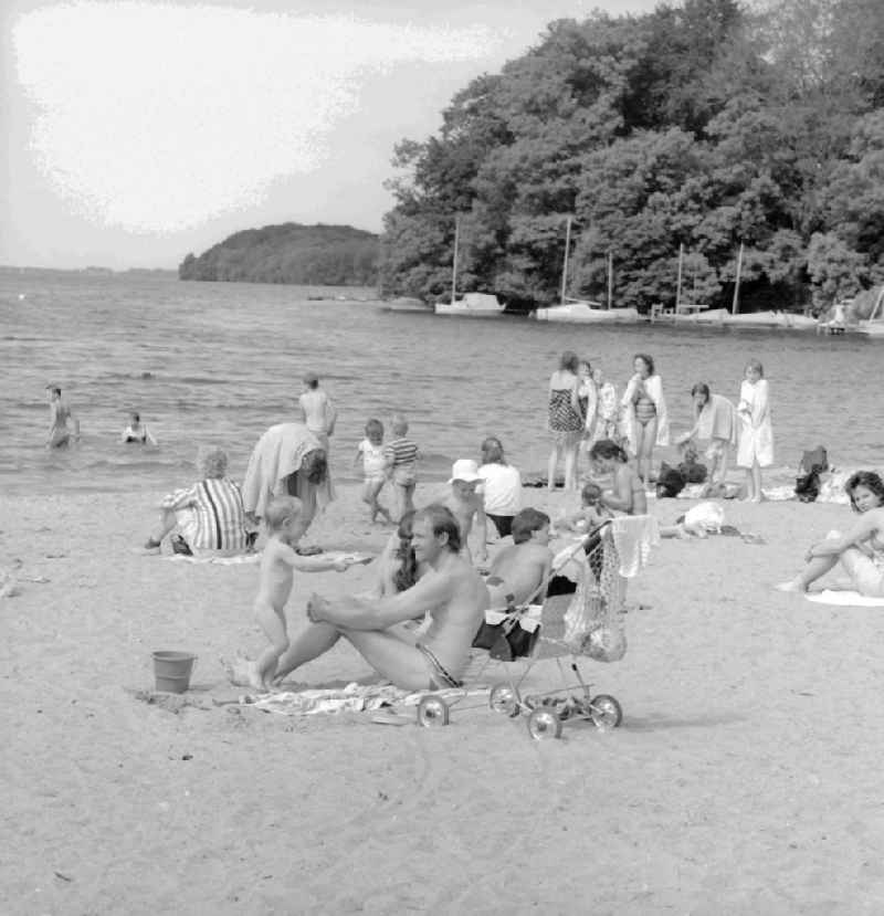 Bathers and vacationers on the beach of the Schweriner Innensees in Schwerin in the federal state Mecklenburg-West Pomerania in the area of the former GDR, German democratic republic