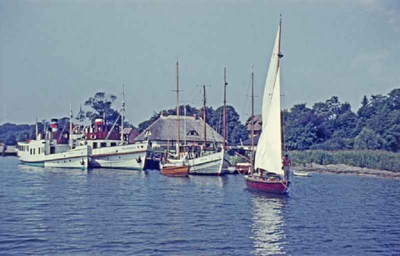 Ships lying at anchor and moored on the Greifswalder Bodden of the Baltic Sea in Sellin, Mecklenburg-Western Pomerania on the territory of the former GDR, German Democratic Republic
