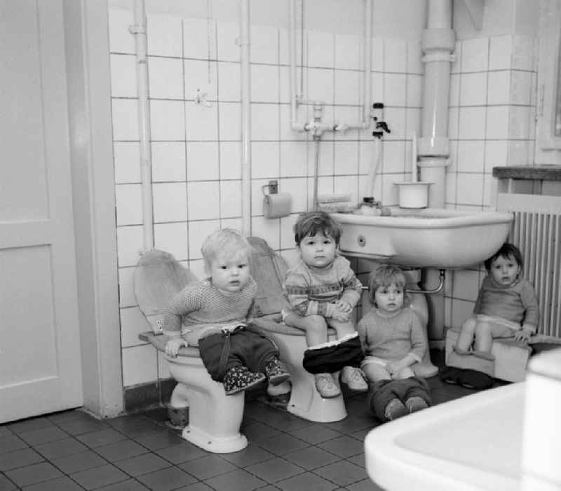Everyday life in a baby cot in Silbitz in today s state of Thuringia. Children sit on the lavatory and the potty