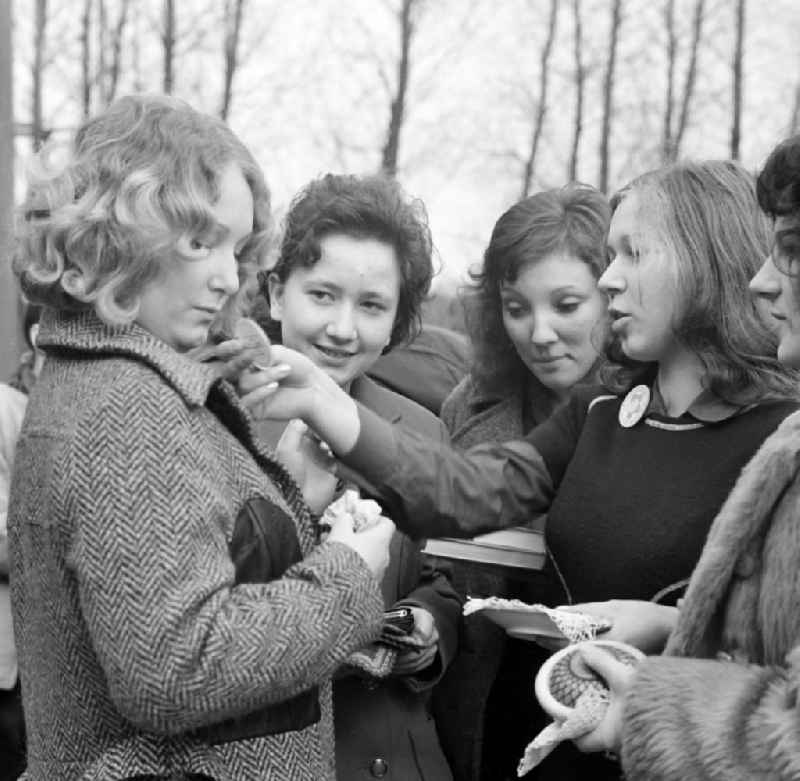 A student distributes pins at an auction on a schoolyard in Spremberg in the state of Brandenburg on the territory of the former GDR, German Democratic Republic
