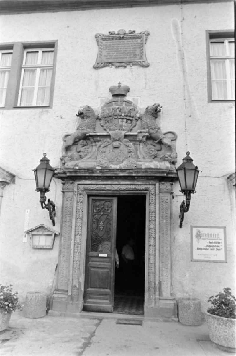 Main portal in the courtyard of the castle FDGB Ferienheim ' Comenius ' in Stolberg (Harz) in the federal state of Saxony-Anhalt in the territory of the former GDR, German Democratic Republic. To the right of the portal is a sign with the inscription 'Entrance to the restaurant Schlossstube Weinstube mit Bar'