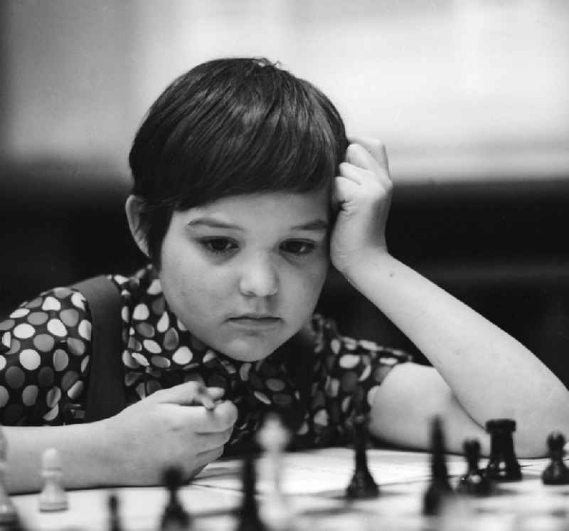 A boy playing chess highly concentrated in Strausberg in Brandenburg on the territory of the former GDR, German Democratic Republic