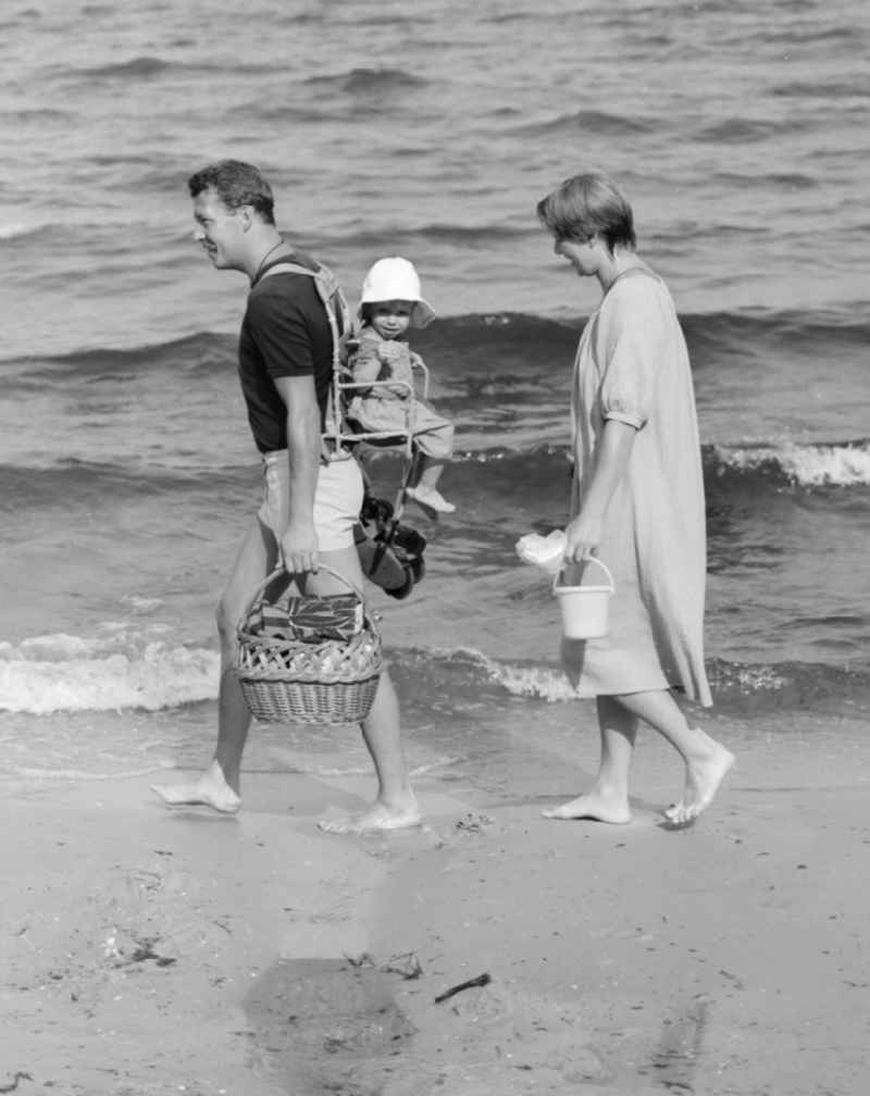 A family goes on the Baltic Sea beach in Ueckeritz walk, in the state of Mecklenburg-Western Pomerania in the field of the former GDR, German Democratic Republic