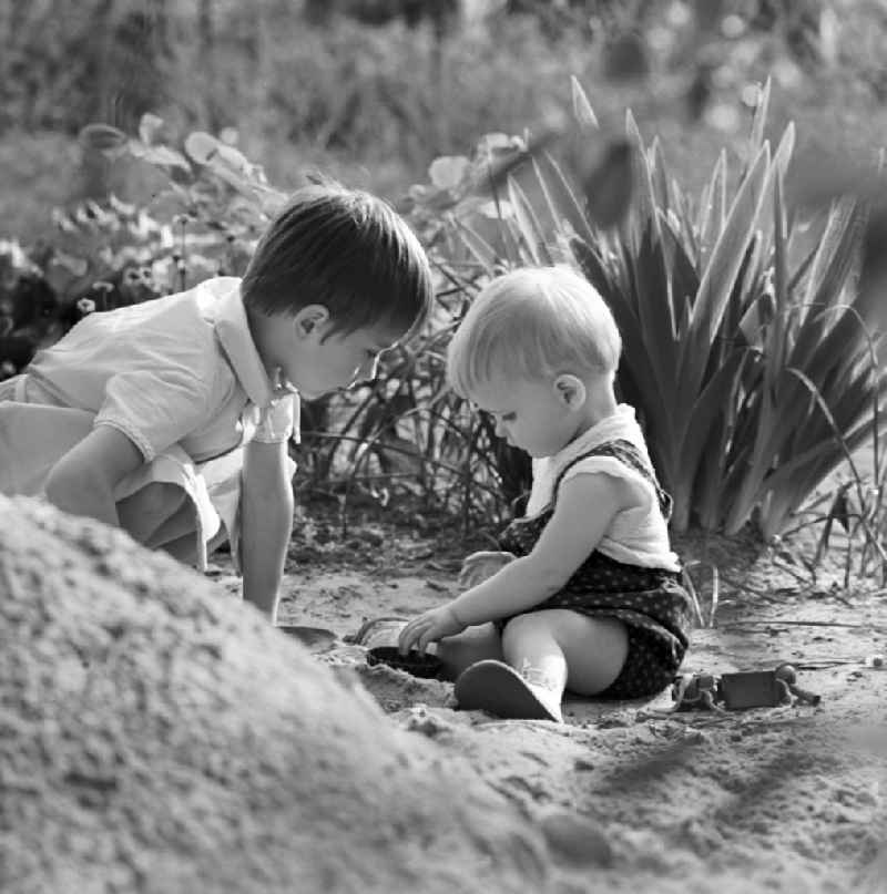 Two children playing in the sand in Warnemünde in Mecklenburg - Western Pomerania