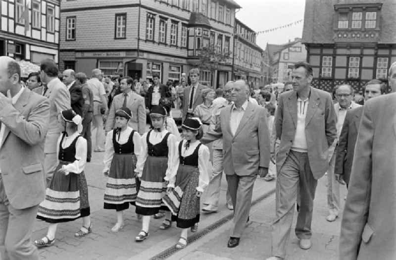 Kurt Hager, the highest cultural official in the SED Politburo, and Werner Eberlein, 1st Secretary of the SED Magdeburg District Leadership, visiting the 21st Workers' Festival in Wernigerode, Saxony-Anhalt in the territory of the former GDR, German Democratic Republic. Girls in typical costumes walk next to the politicians