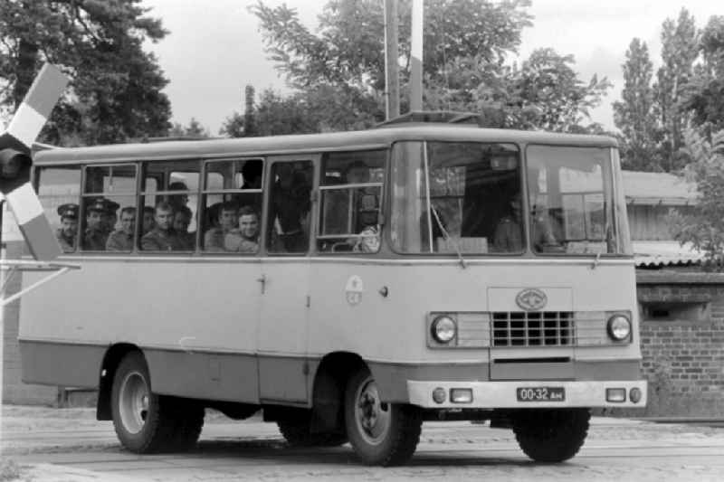 Soviet soldiers in uniform of the Red Army of the GSSD 'Group of Soviet Forces in Germany' ride in a minibus military vehicle 'Progress-3