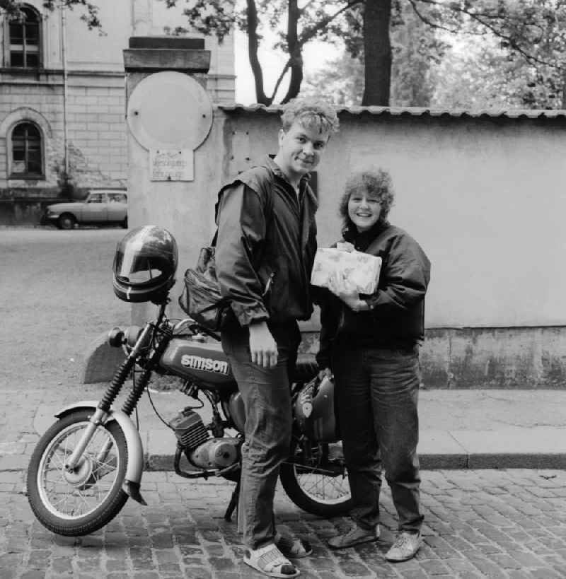 Two adolescents with a Simson motorbike in Zittau in the state Saxony on the territory of the former GDR, German Democratic Republic
